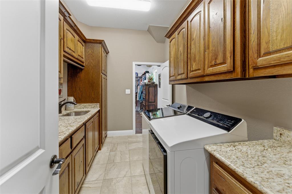 10106 Prather Road Springtown, TX 76082 - Photo 24 of 40 a kitchen with a sink stove and cabinets