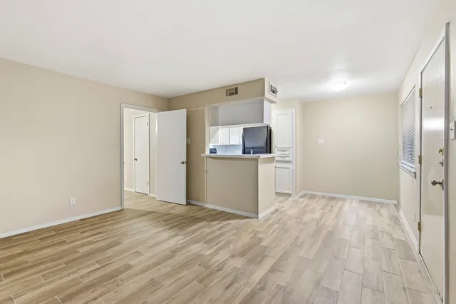 a view of a kitchen with wooden floor and a sink