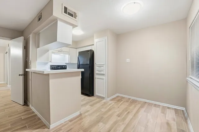 a kitchen with stainless steel appliances a refrigerator and a stove