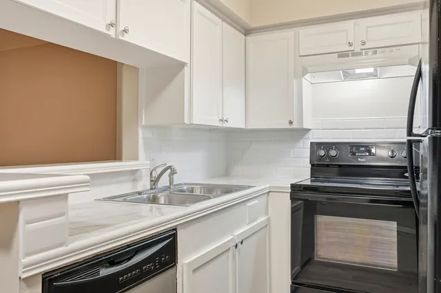 a kitchen with a sink stove and cabinets