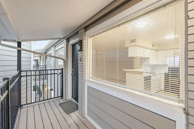 a view of a balcony with wooden floor