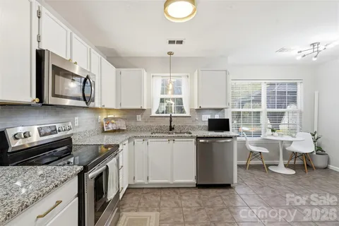 a kitchen with a sink stove and microwave