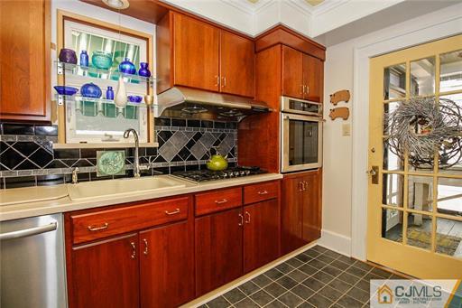 67 Pleasant Avenue Edison, NJ 08837 - Photo 12 of 25 a kitchen with stainless steel appliances granite countertop a refrigerator and a sink