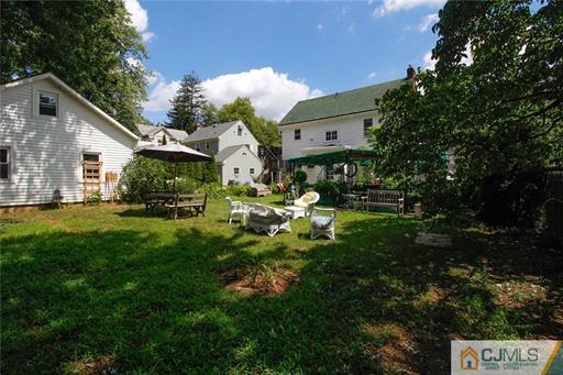 67 Pleasant Avenue Edison, NJ 08837 - Photo 23 of 25 a front view of a house with a yard table and chairs