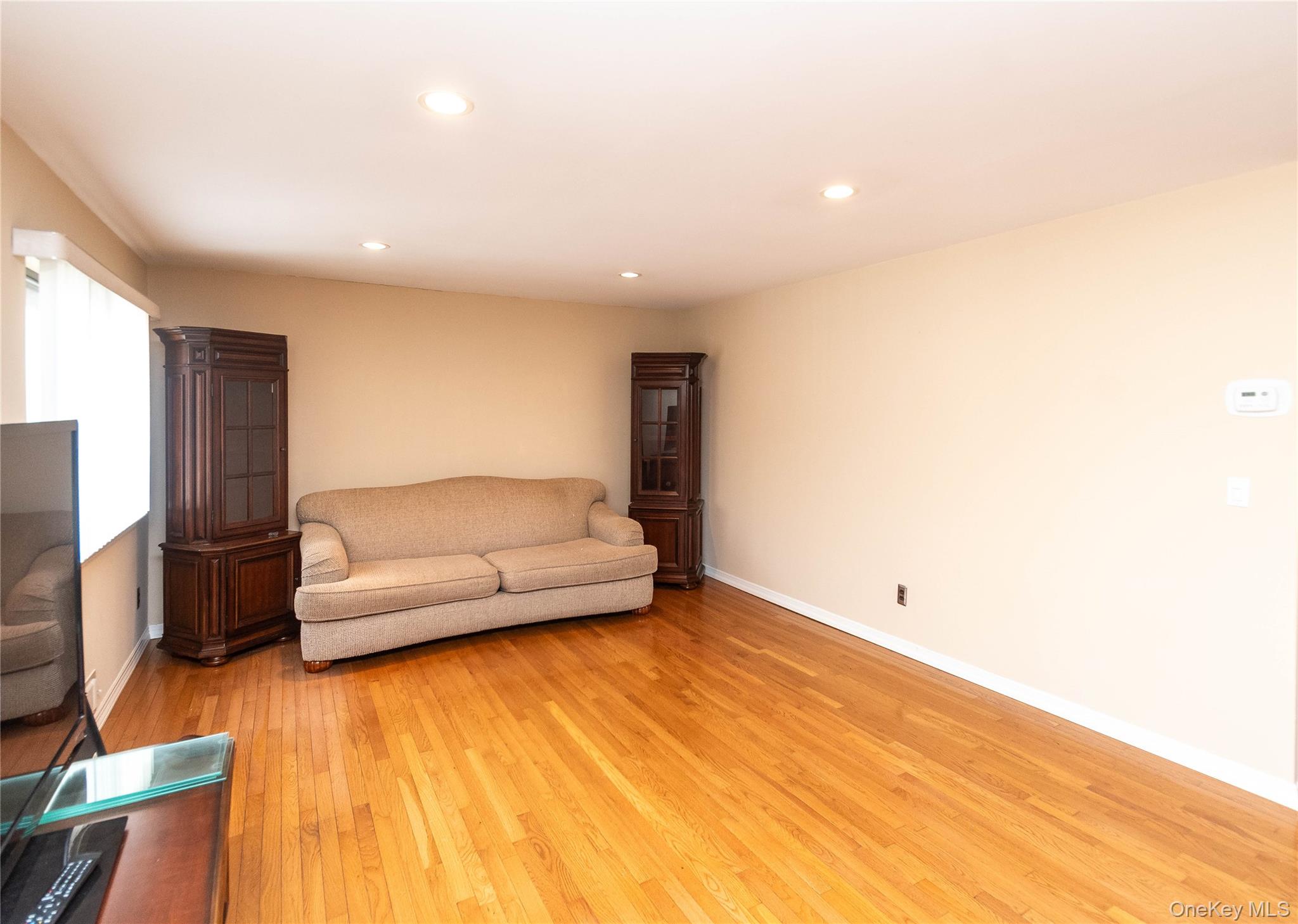 113 Village Road, Unit B Yorktown Heights, NY 10598 - Photo 11 of 25 a living room with a couch and a wooden floor
