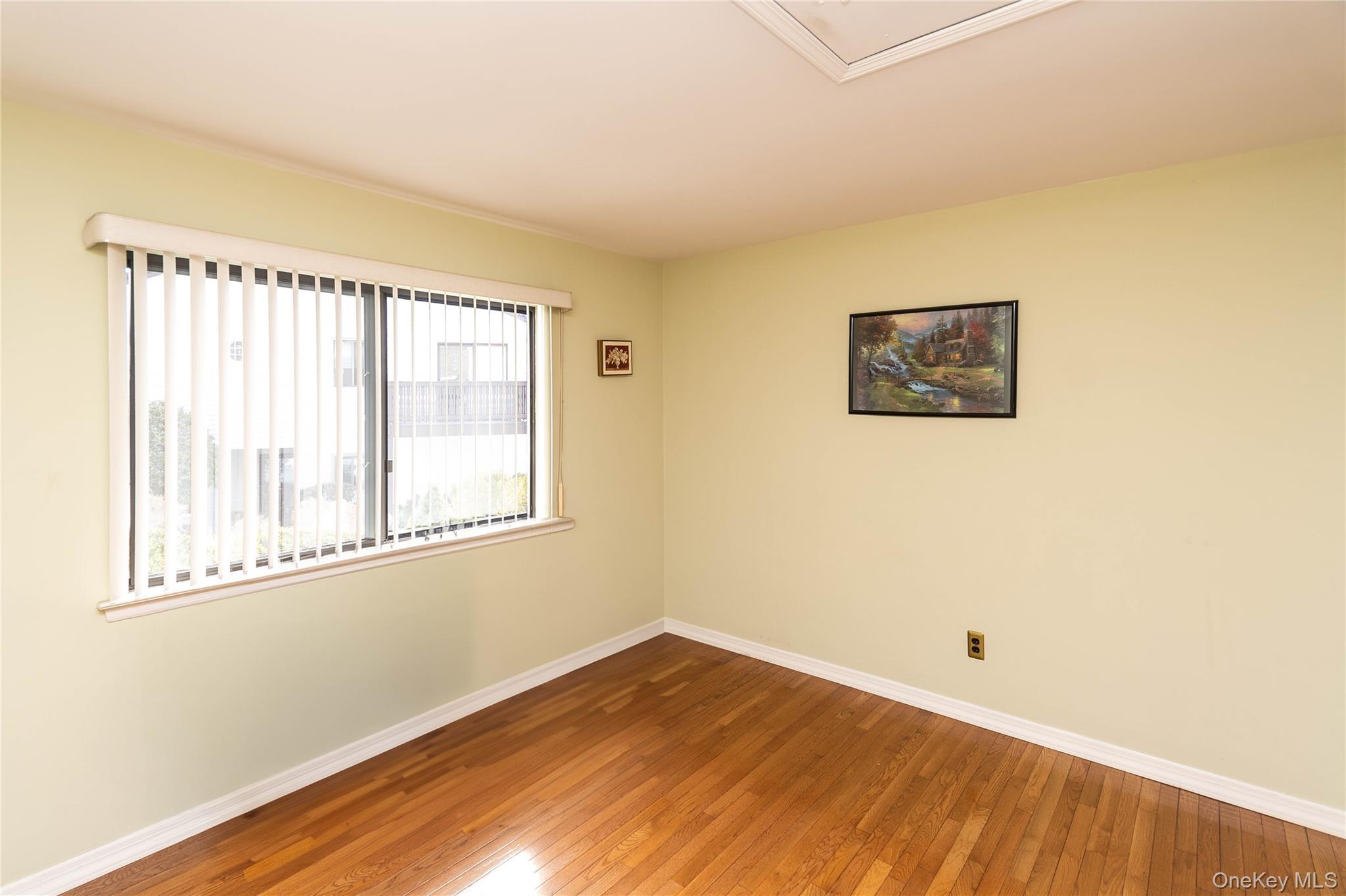 113 Village Road, Unit B Yorktown Heights, NY 10598 - Photo 12 of 25 a view of an empty room with wooden floor and a window