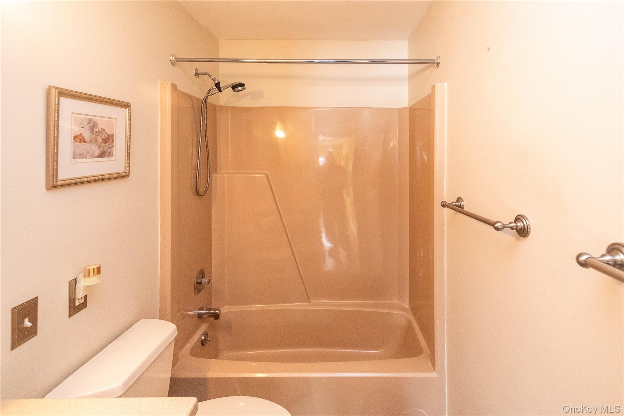 113 Village Road, Unit B Yorktown Heights, NY 10598 - Photo 17 of 25 a bathroom with a granite countertop bathtub shower and a sink