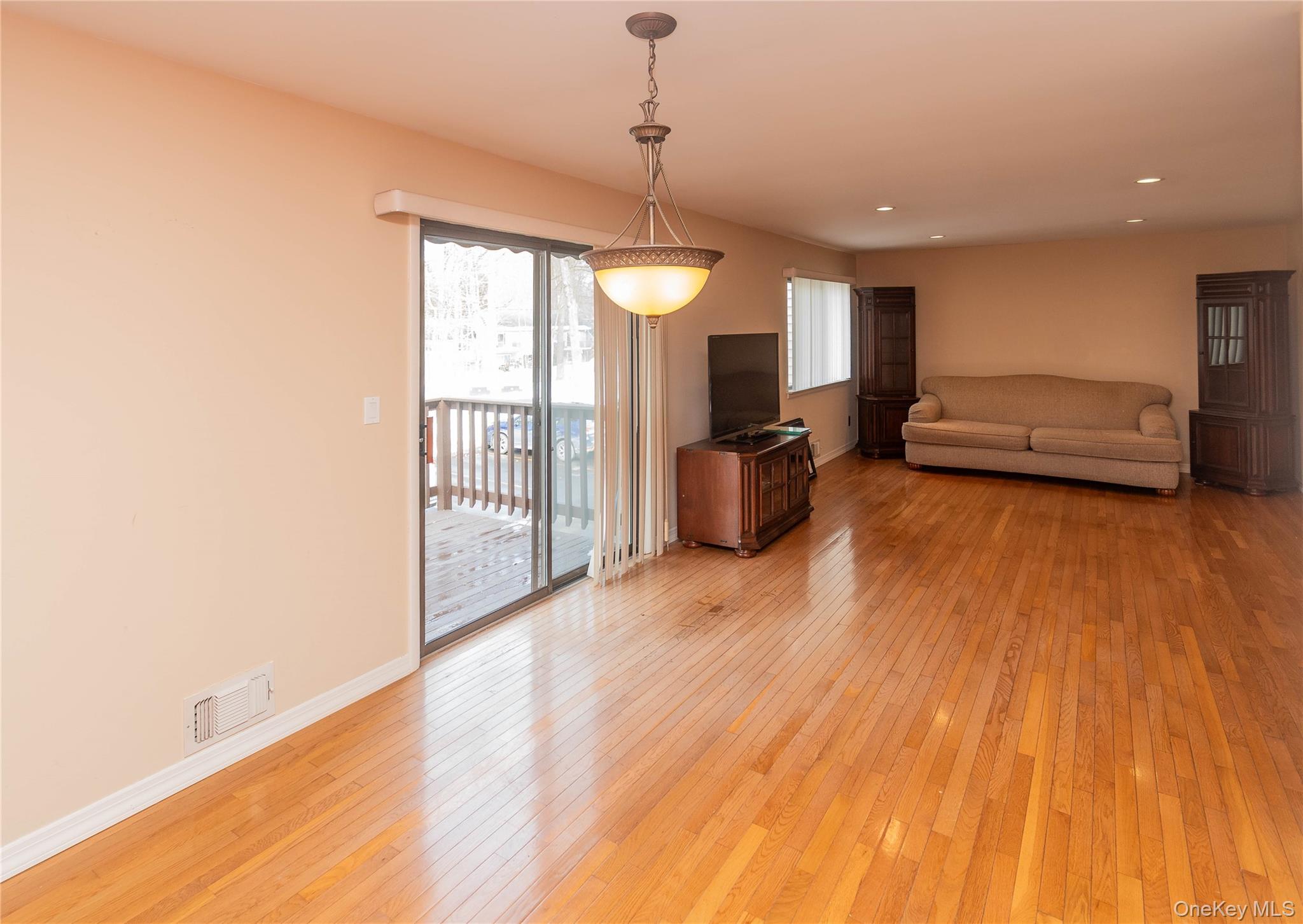113 Village Road, Unit B Yorktown Heights, NY 10598 - Photo 18 of 25 a view of a livingroom with furniture wooden floor and windows