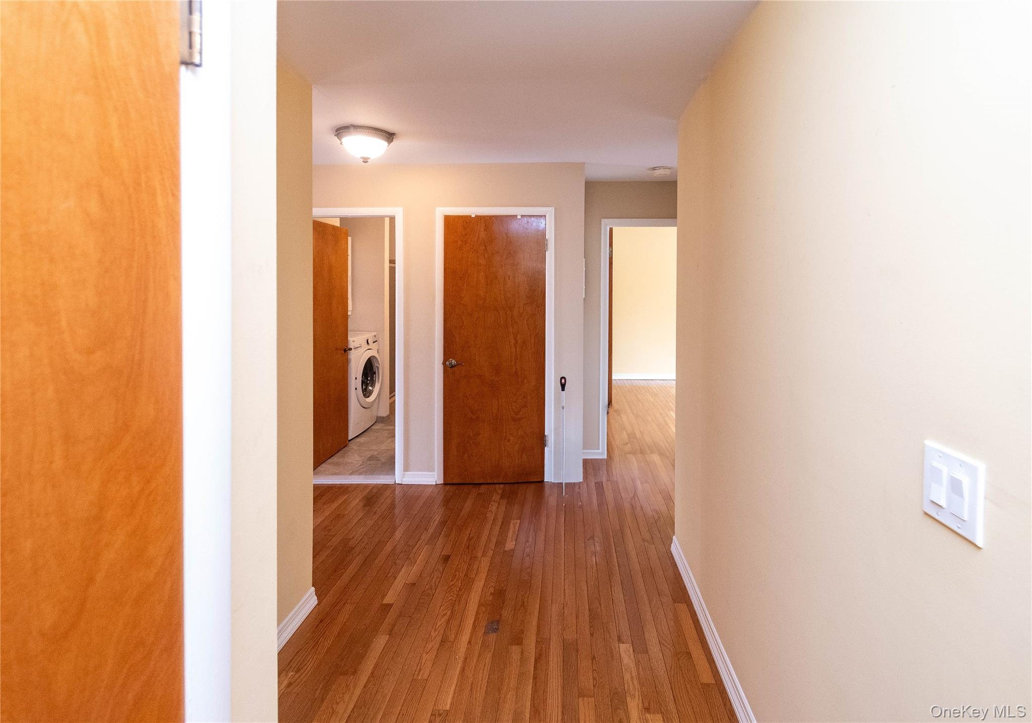 113 Village Road, Unit B Yorktown Heights, NY 10598 - Photo 5 of 25 a view of a hallway with wooden floor