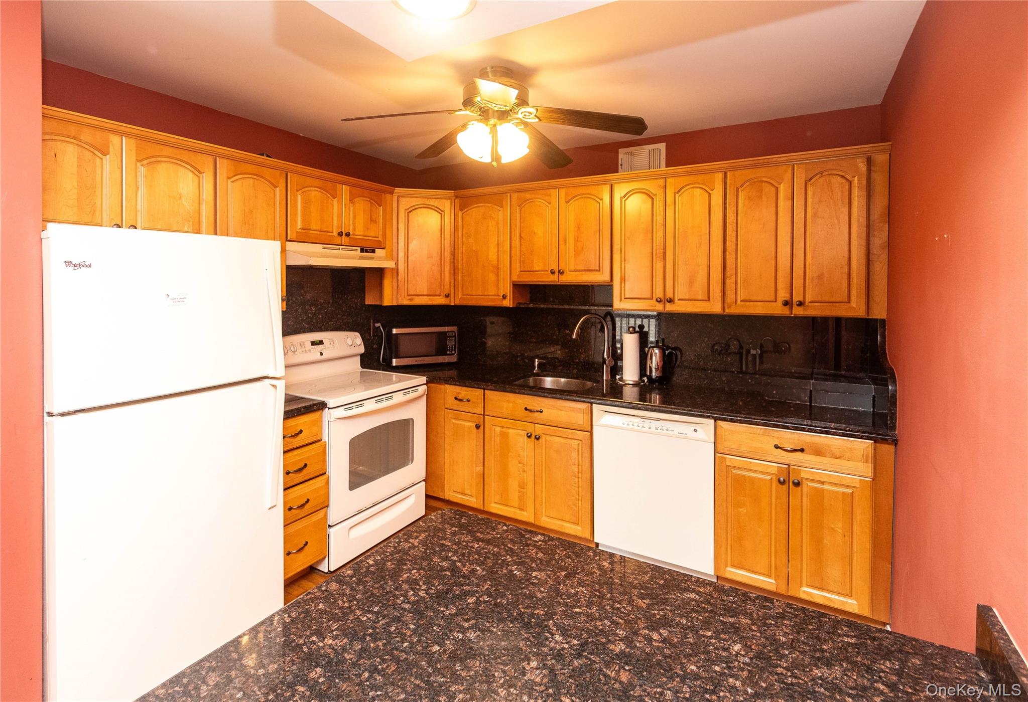 113 Village Road, Unit B Yorktown Heights, NY 10598 - Photo 6 of 25 a kitchen with stainless steel appliances a refrigerator sink and cabinets