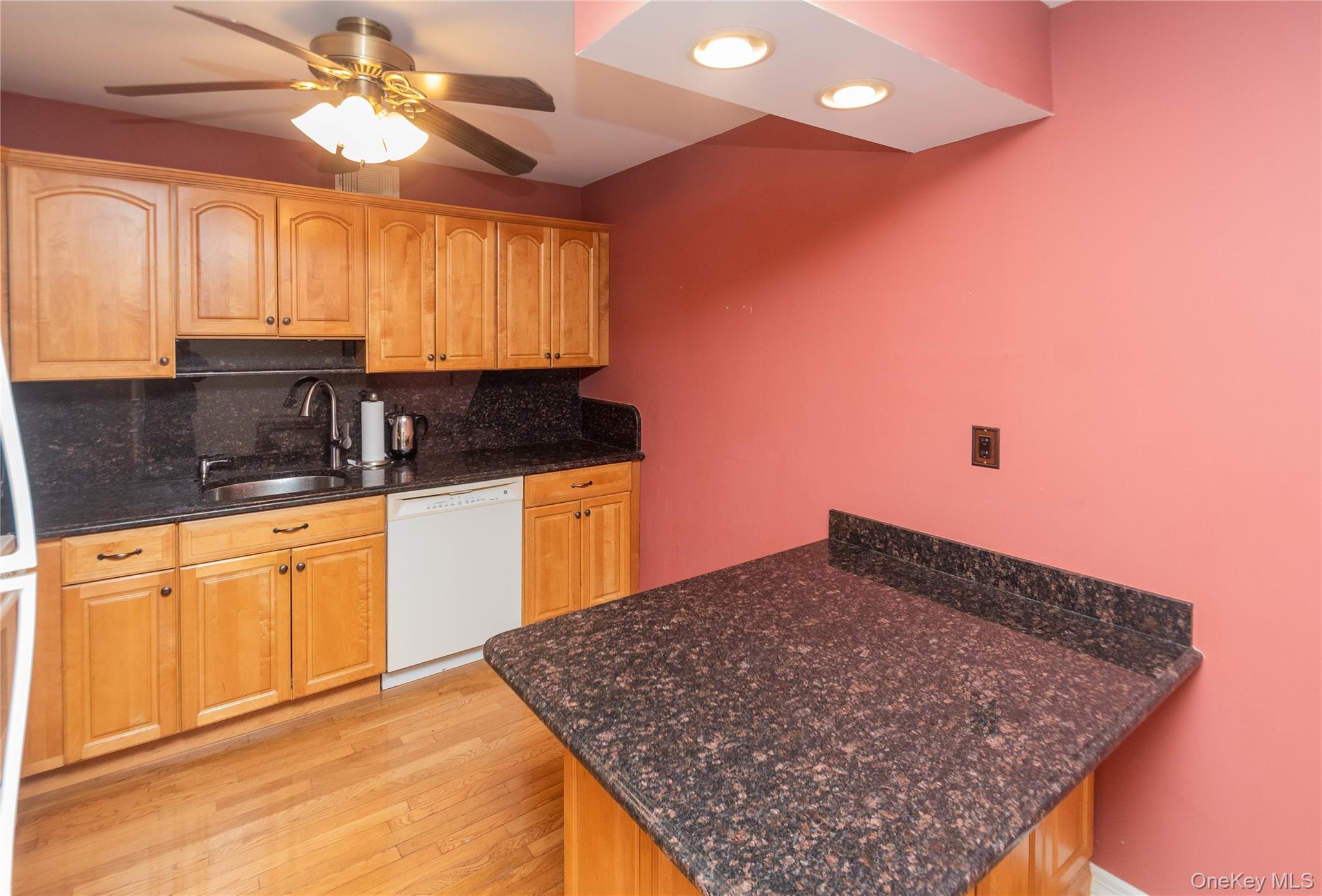 113 Village Road, Unit B Yorktown Heights, NY 10598 - Photo 7 of 25 a kitchen with stainless steel appliances granite countertop a sink stove and cabinets