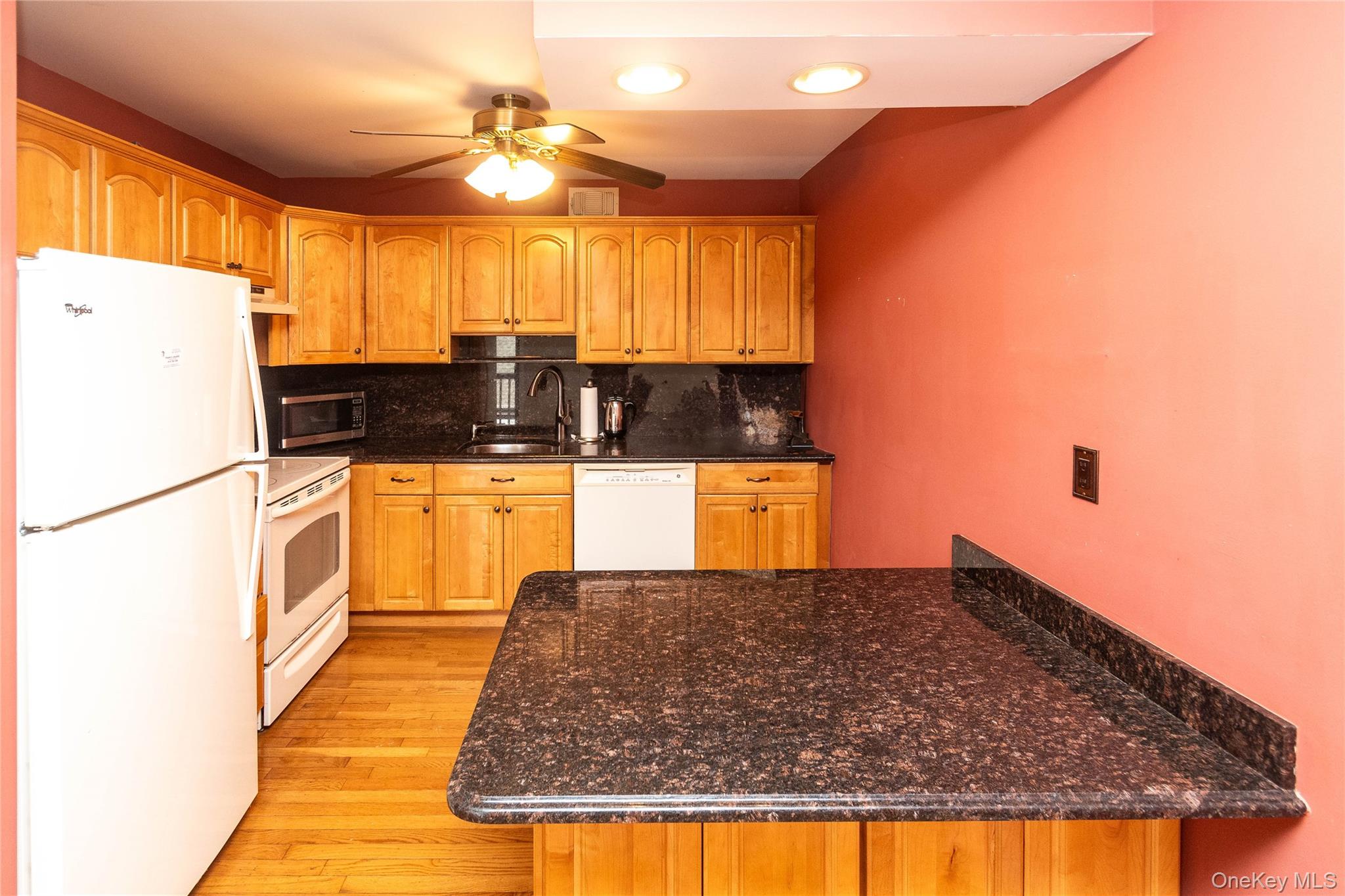 113 Village Road, Unit B Yorktown Heights, NY 10598 - Photo 8 of 25 a kitchen with granite countertop a sink a stove and refrigerator