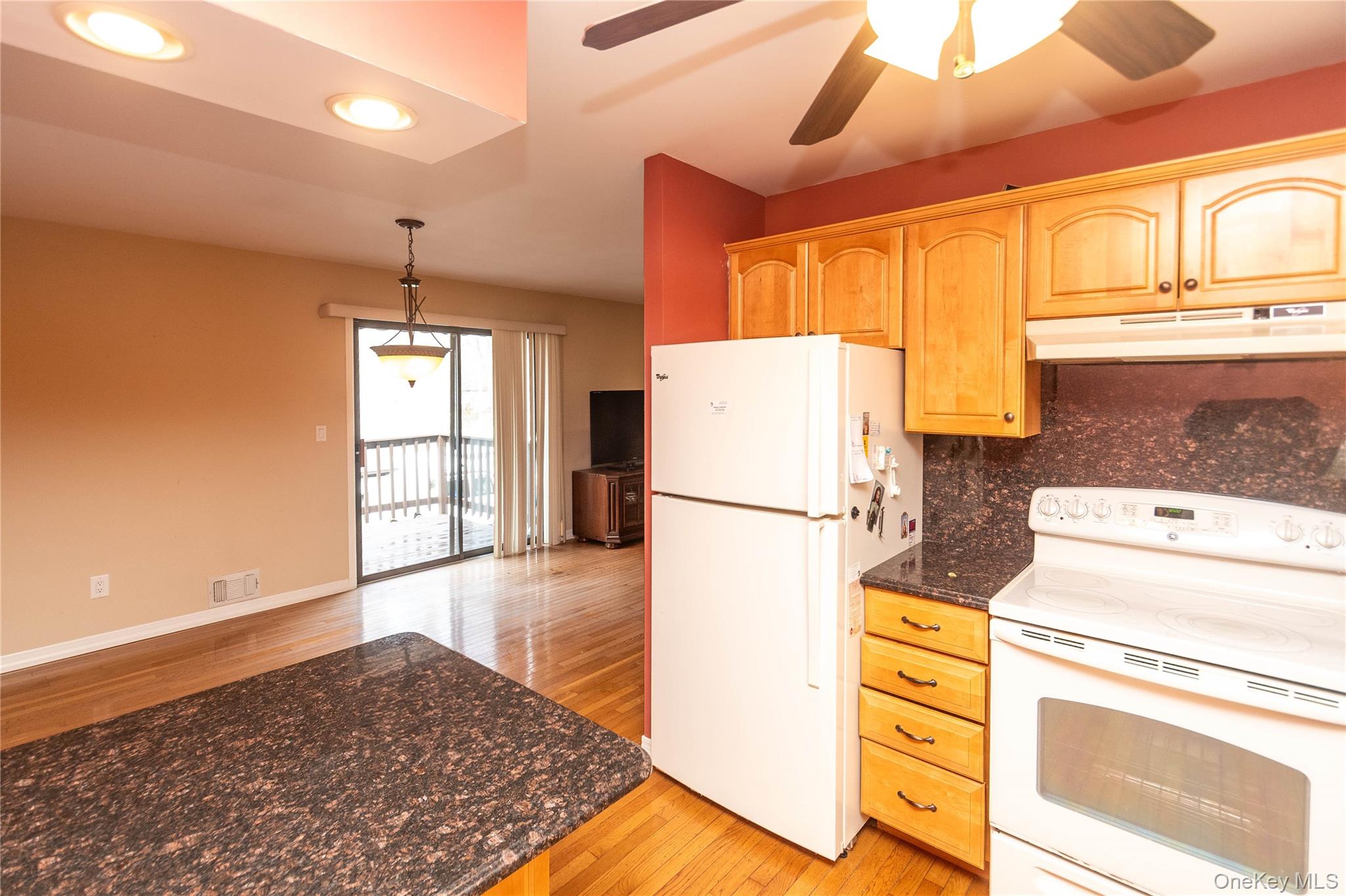 113 Village Road, Unit B Yorktown Heights, NY 10598 - Photo 9 of 25 a kitchen with a refrigerator a stove cabinets and wooden floor