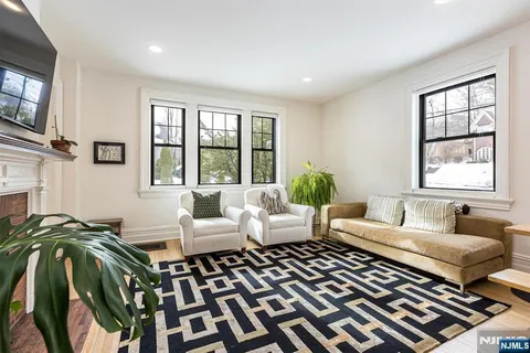 a view of a hallway to a livingroom and a dining room with furniture