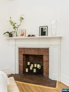a bedroom with a bed and a fireplace