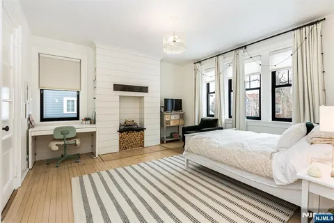 a bedroom with a bed couch and a window