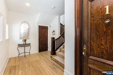 a view of hallway with wooden floor