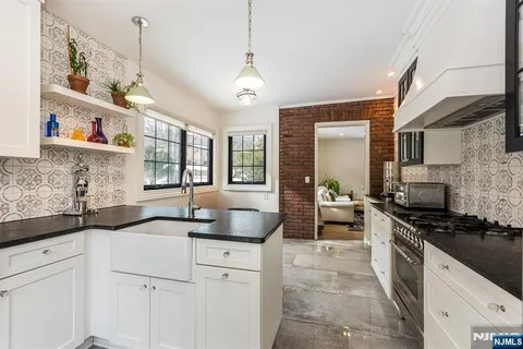 a living room with a rug and a potted plant