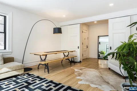 a living room with furniture and a floor to ceiling window