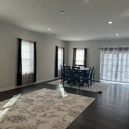 a view of a dining room with furniture and window