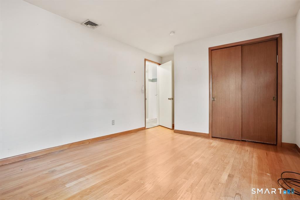 732 Tunxis Hill Road Fairfield, CT 06825 - Photo 11 of 21 a view of an empty room with wooden floor and a window