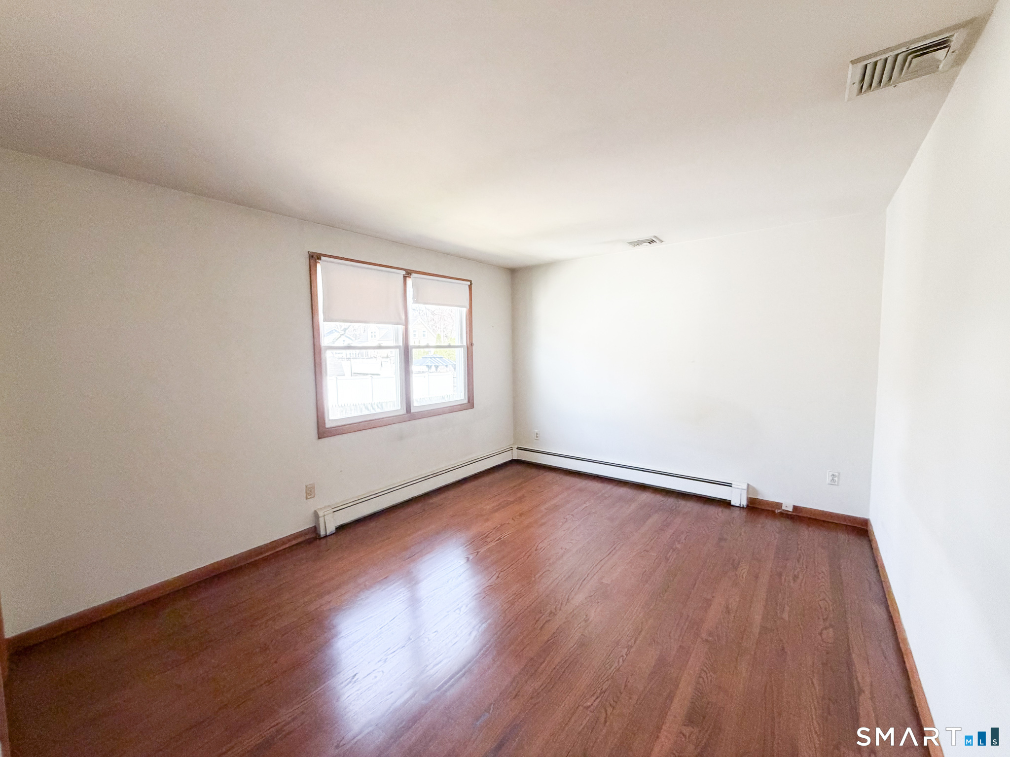 732 Tunxis Hill Road Fairfield, CT 06825 - Photo 12 of 21 an empty room with wooden floor and windows
