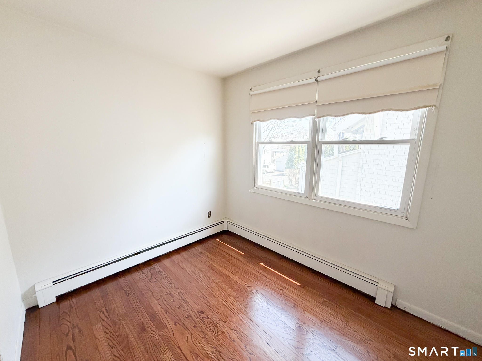 732 Tunxis Hill Road Fairfield, CT 06825 - Photo 15 of 21 an empty room with wooden floor and windows