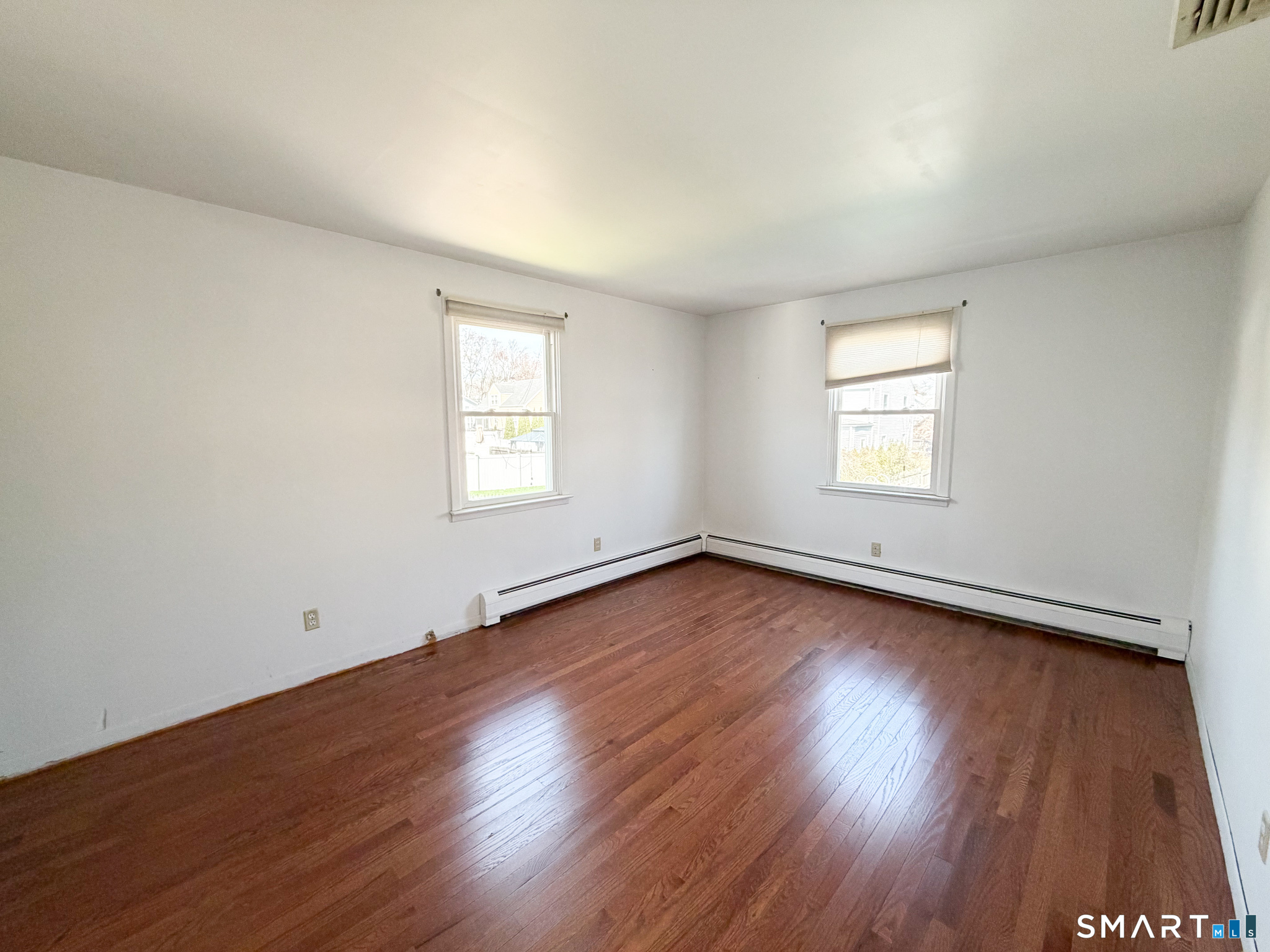 732 Tunxis Hill Road Fairfield, CT 06825 - Photo 16 of 21 an empty room with wooden floor and window