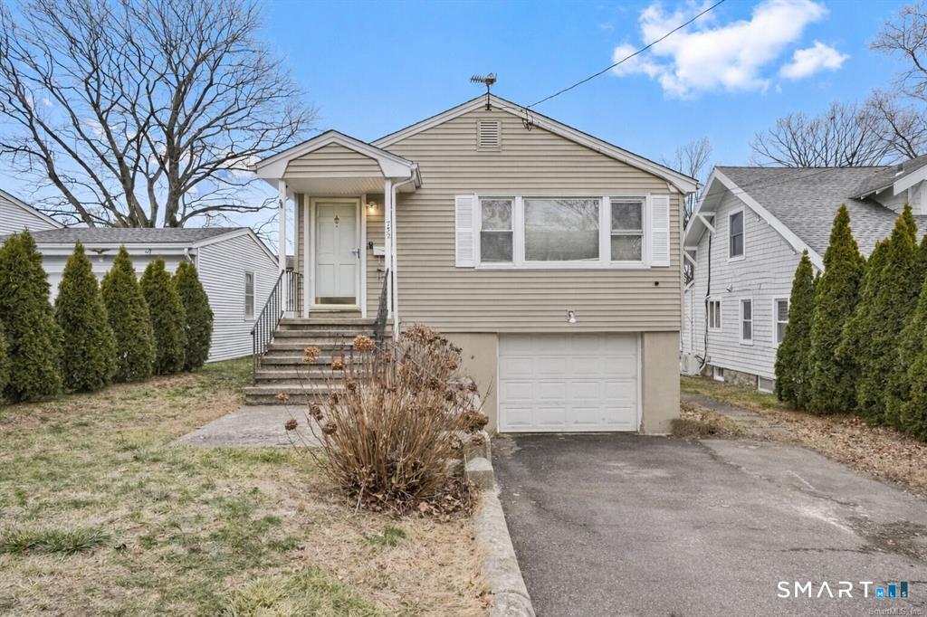 732 Tunxis Hill Road Fairfield, CT 06825 - Photo 2 of 21 a front view of a house with a yard and garage
