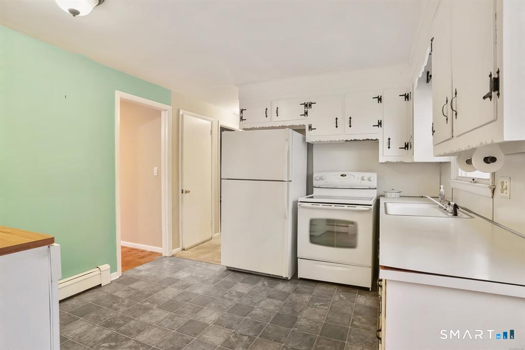 732 Tunxis Hill Road Fairfield, CT 06825 - Photo 3 of 21 a kitchen with stainless steel appliances a refrigerator sink and cabinets