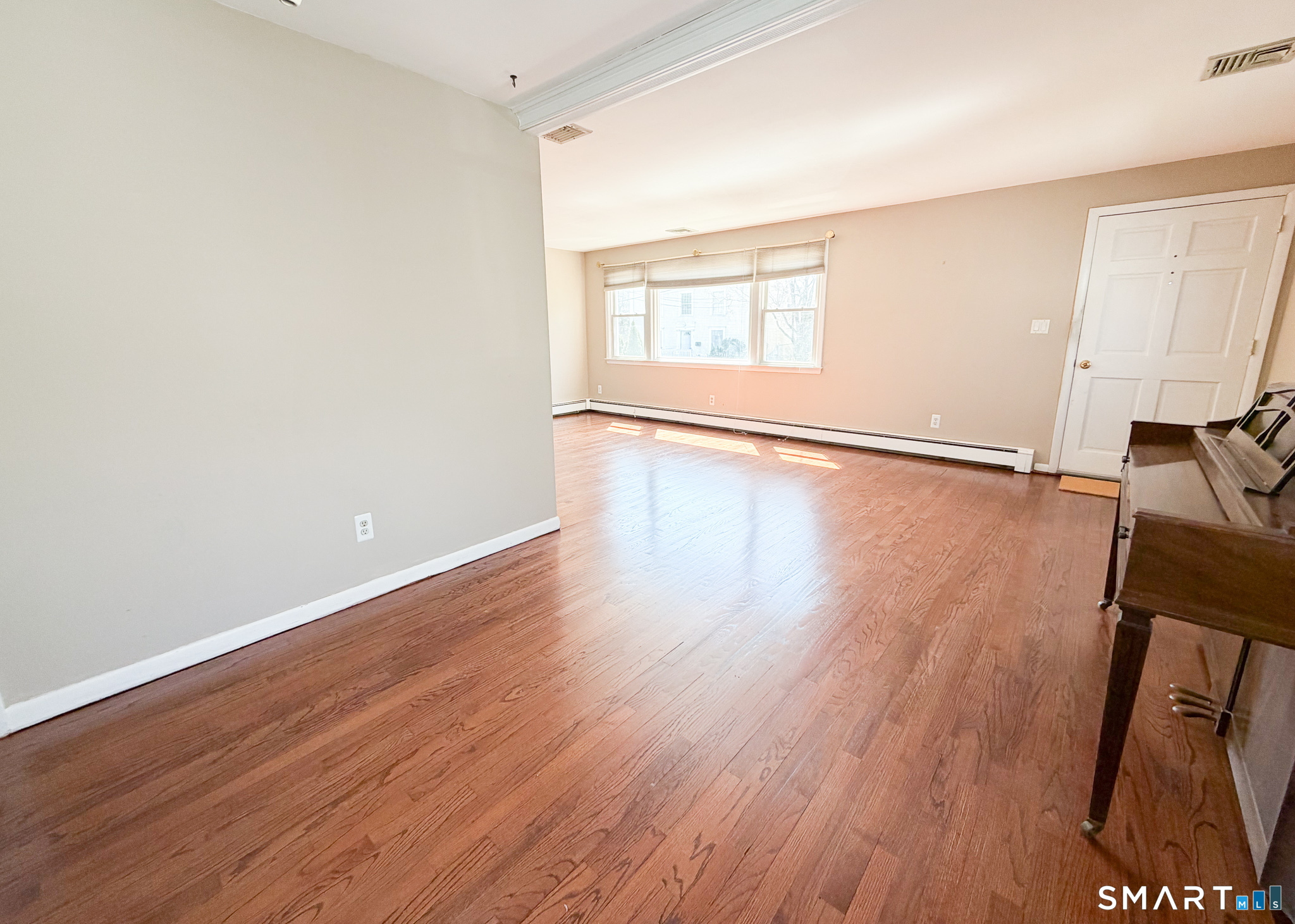 732 Tunxis Hill Road Fairfield, CT 06825 - Photo 6 of 21 an empty room with wooden floor and windows