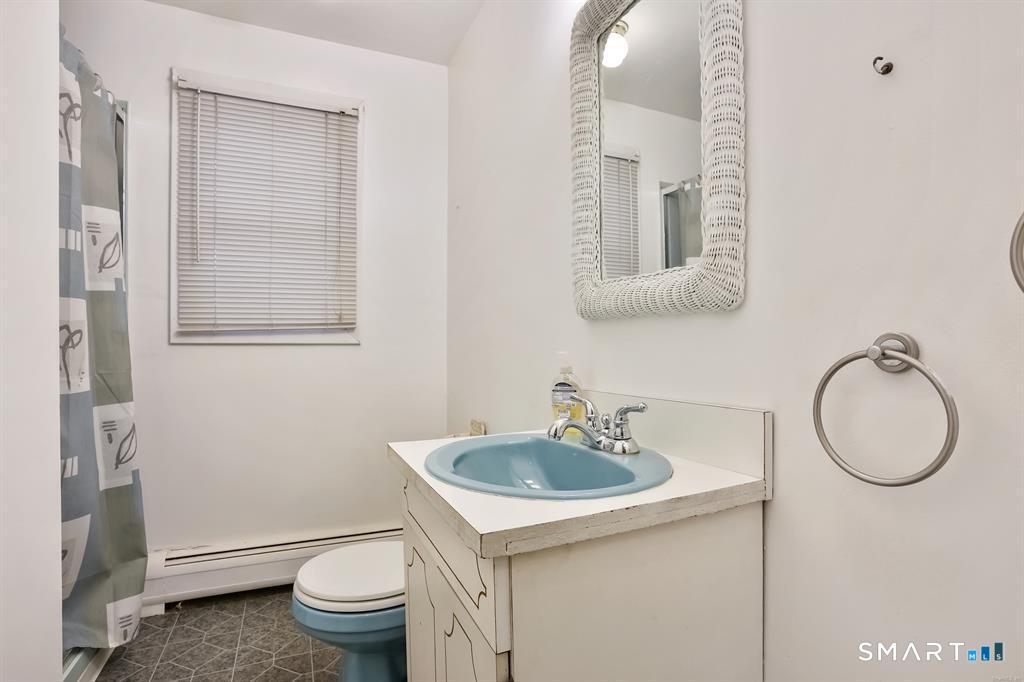 732 Tunxis Hill Road Fairfield, CT 06825 - Photo 10 of 21 a bathroom with a toilet sink and mirror