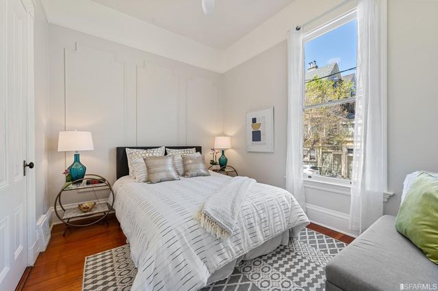 a bedroom with a bed lamps and window