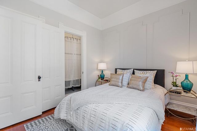 a bedroom with a bed and a lamp