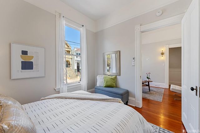 a bedroom with a bed and a window