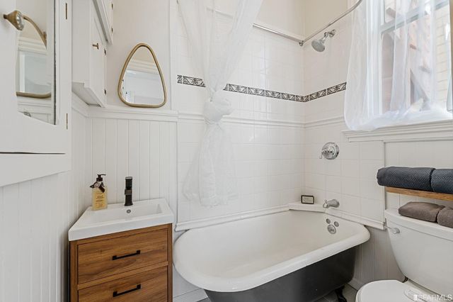 a bathroom with a sink a toilet and a shower