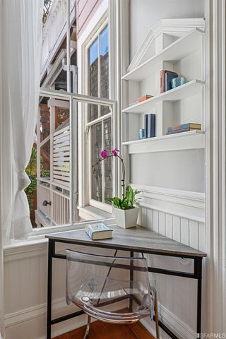 a view of staircase with wooden floor and chair