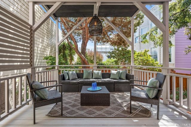 a view of a chair and tables in the balcony