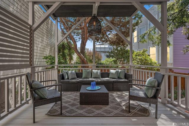 a view of a chair and tables in the balcony