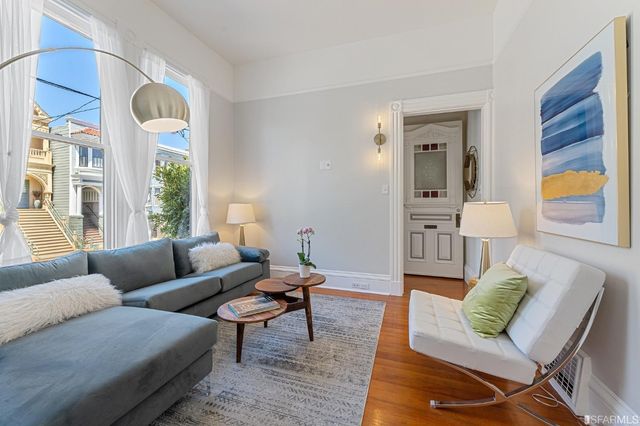 a living room with furniture and a lamp