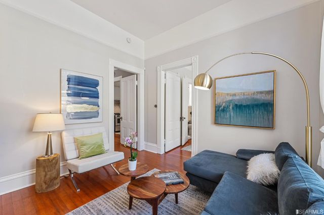 a living room with furniture and a lamp