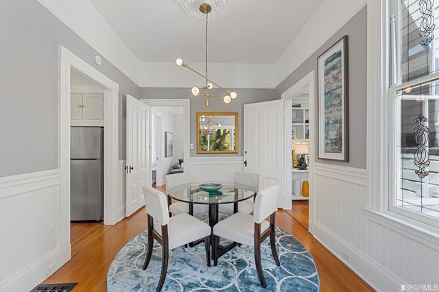 a view of a dining room with furniture window and wooden floor