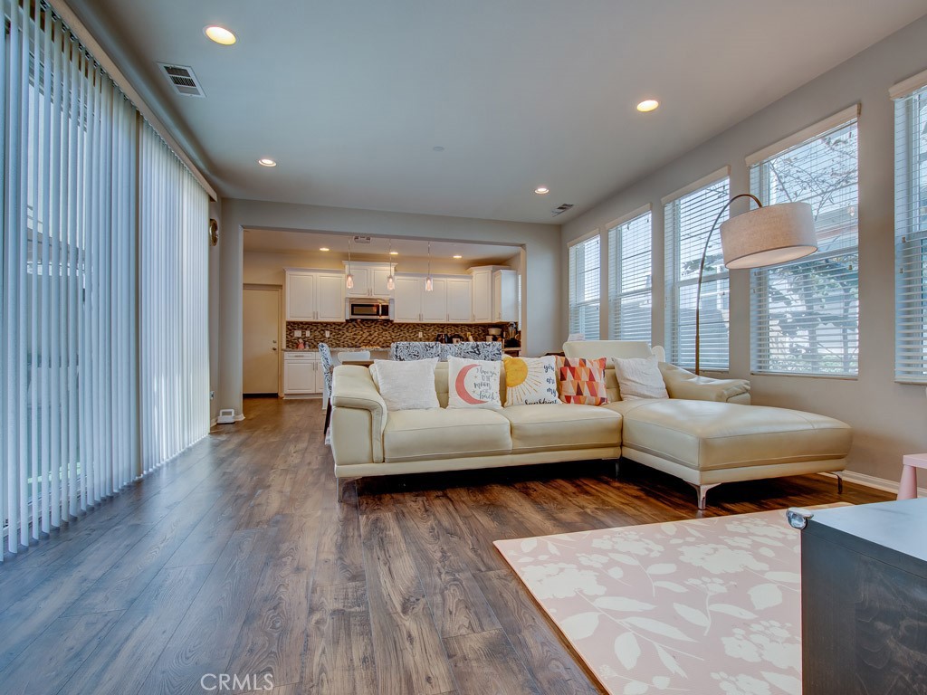 147 Acamar Irvine, CA 92618 - Photo 12 of 52 a living room with furniture and a wooden floor