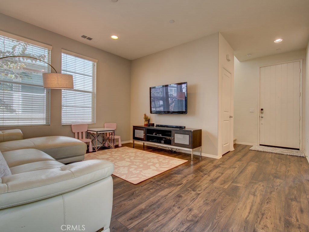 147 Acamar Irvine, CA 92618 - Photo 15 of 52 a living room with furniture a window and a flat screen tv