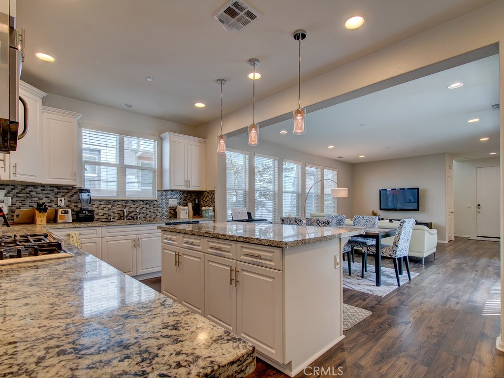 147 Acamar Irvine, CA 92618 - Photo 18 of 52 a kitchen with a sink stove and wooden cabinets