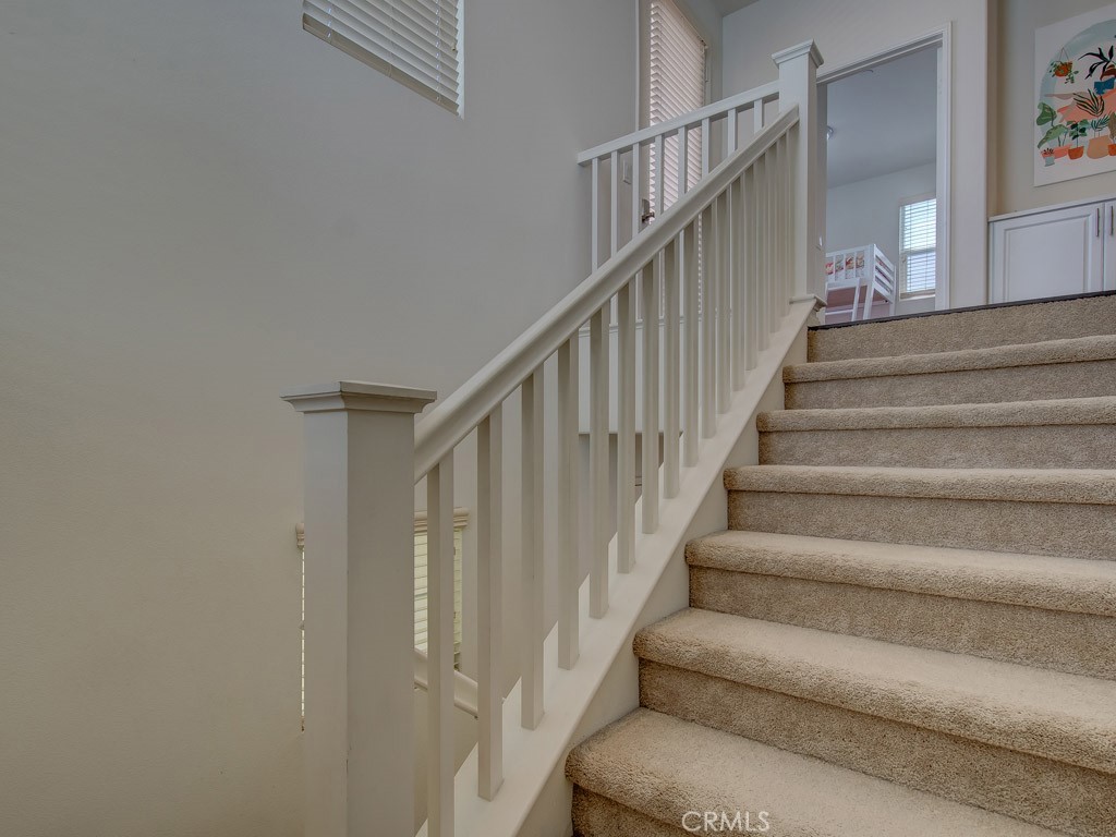 147 Acamar Irvine, CA 92618 - Photo 22 of 52 a view of staircase with lots of frames on wall and stairs