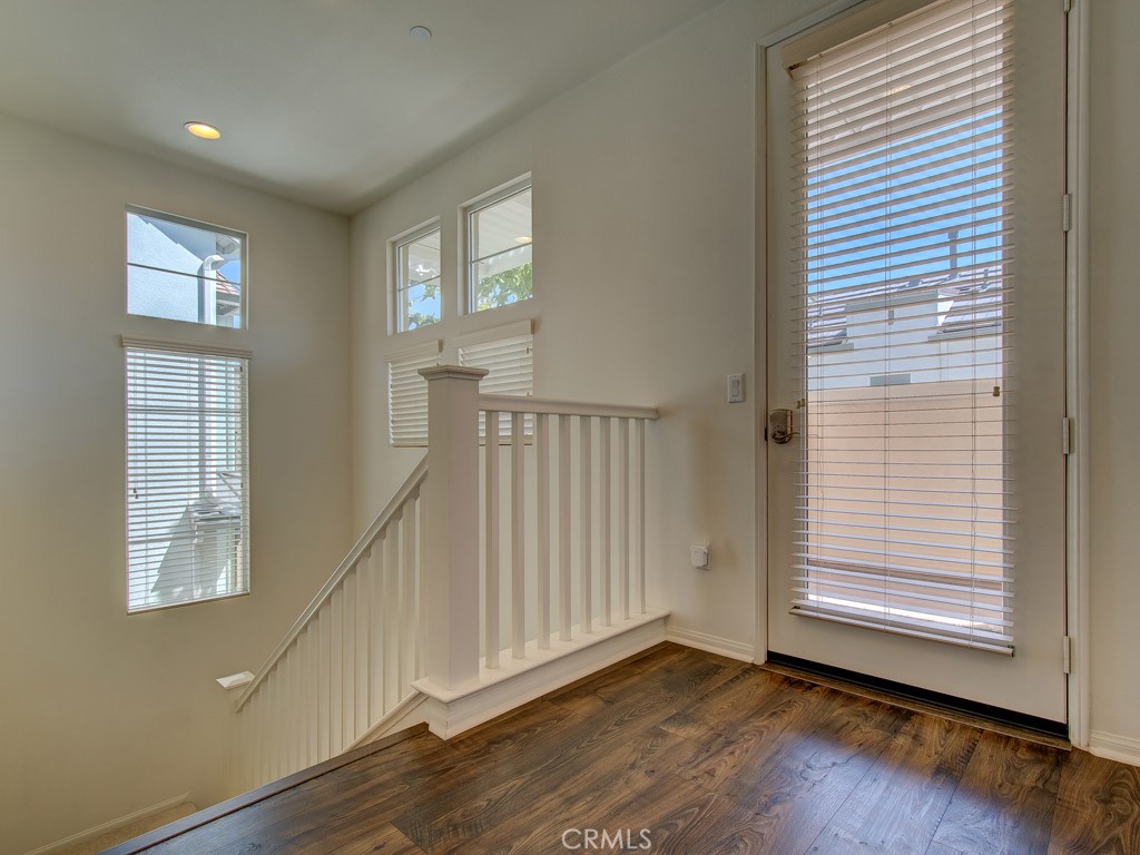 147 Acamar Irvine, CA 92618 - Photo 25 of 52 a view of an empty room with wooden floor and a window