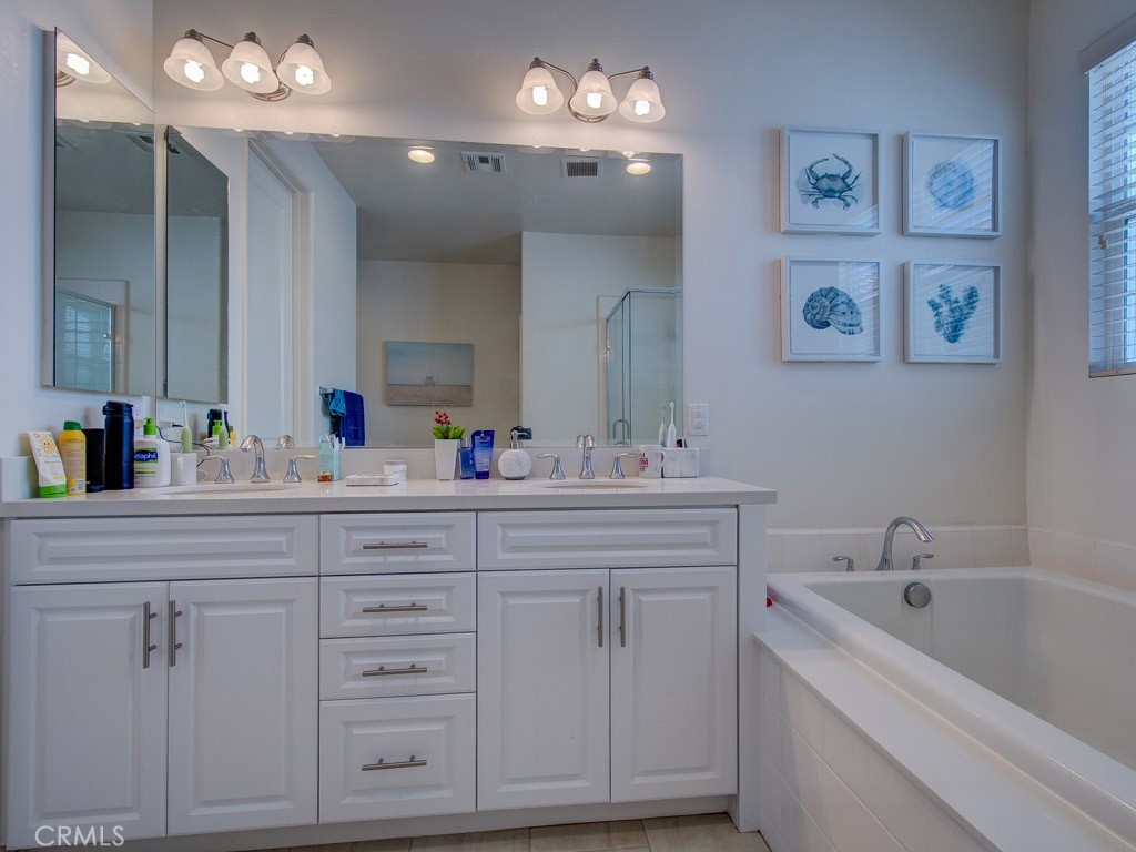 147 Acamar Irvine, CA 92618 - Photo 41 of 52 a bathroom with a sink double vanity and a mirror