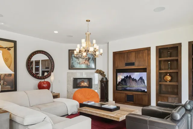 a living room with furniture windows and wooden floor