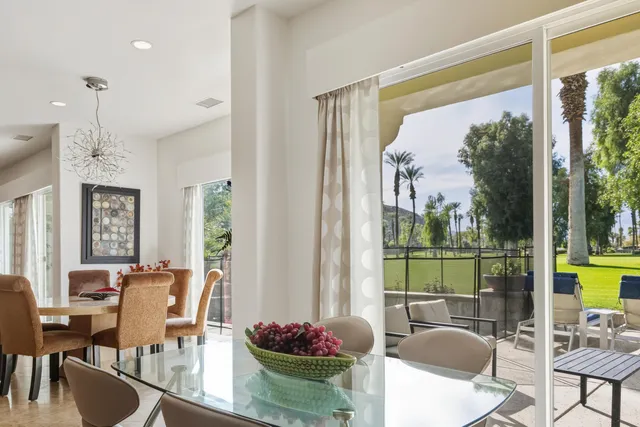 a view of a dining room with furniture wooden floor and a chandelier